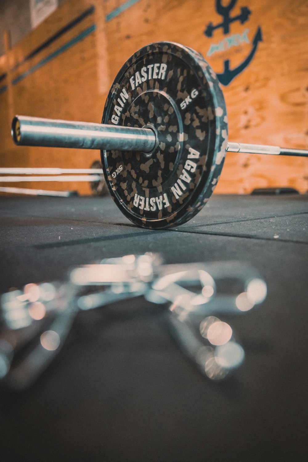 a close up of a barbell on a gym floor