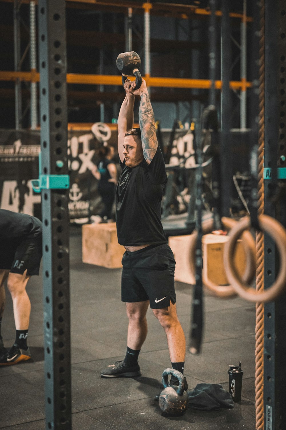 a man doing a pull up in a gym