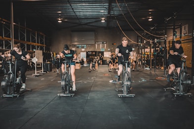 a group of people riding stationary bikes in a gym