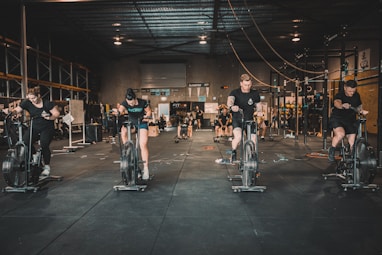 a group of people riding stationary bikes in a gym