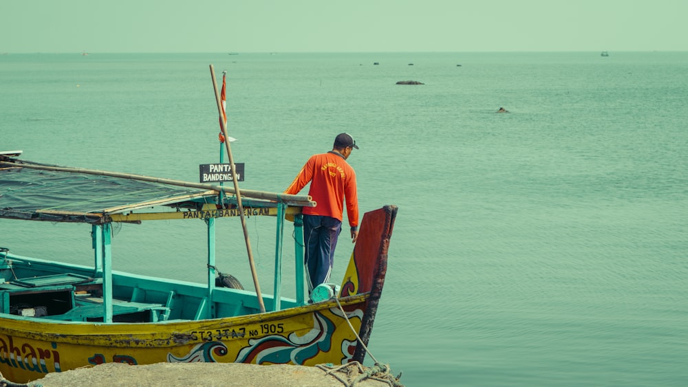 a man standing on top of a boat in the ocean