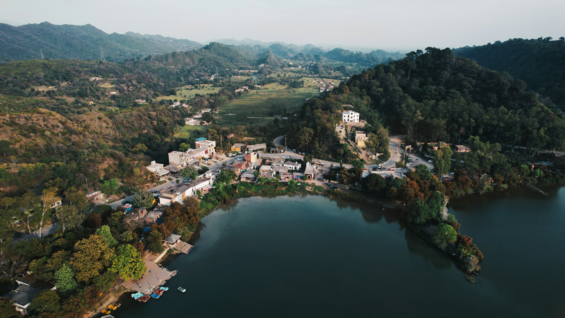 an aerial view of a village and a lake