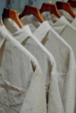 Close-up of a soft, colorful women's blouse displayed on a hanger against a clean background.