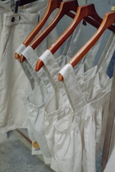 Comfortable, earth-toned organic cotton clothing displayed on hangers.