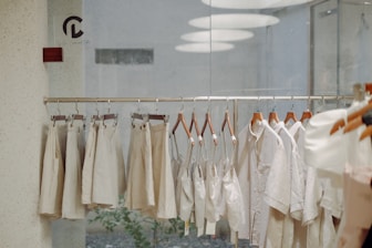 a bunch of clothes hanging on a rack in a room