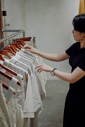 A user organizing clothes on a digital wardrobe app interface