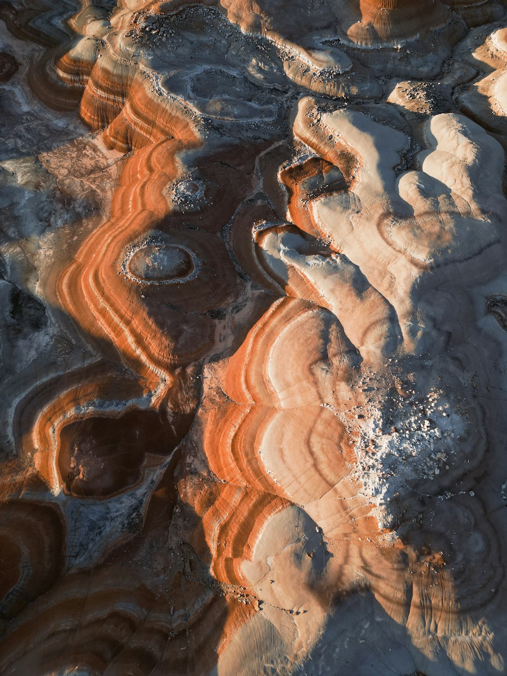 an aerial view of a rocky landscape with orange and white colors