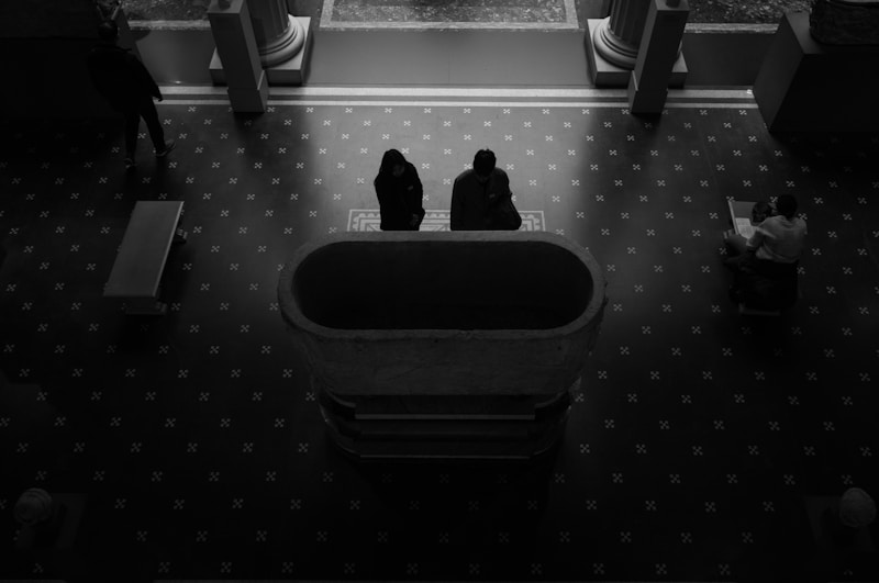 a couple of people sitting on a bench in a room