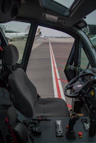 Side view of a container dolly designed for easy maneuvering on airport grounds.