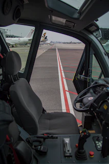 Side view of a container dolly designed for easy maneuvering on airport grounds.