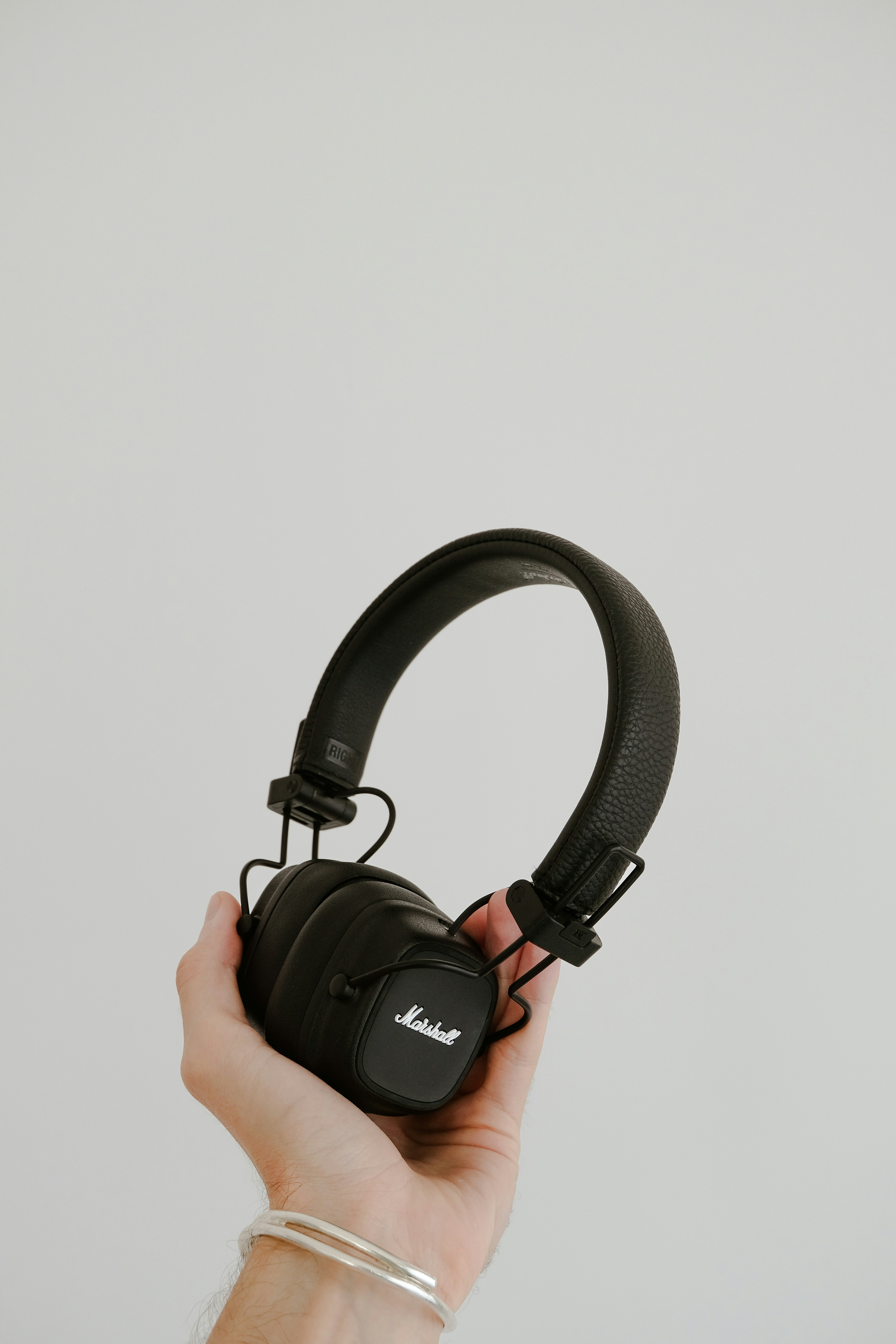 a person holding a pair of headphones in their hand