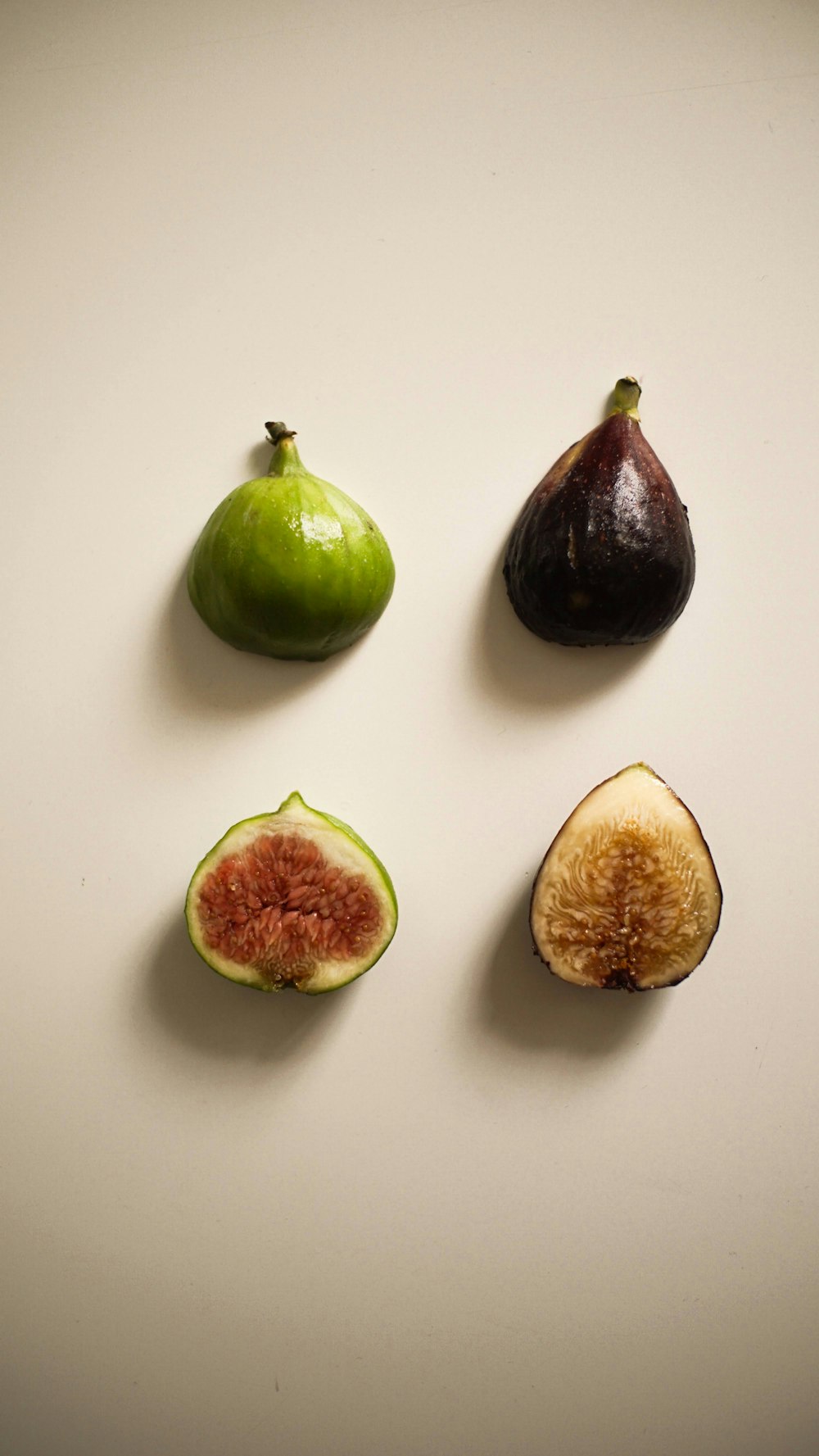 a group of fruit sitting on top of a white table