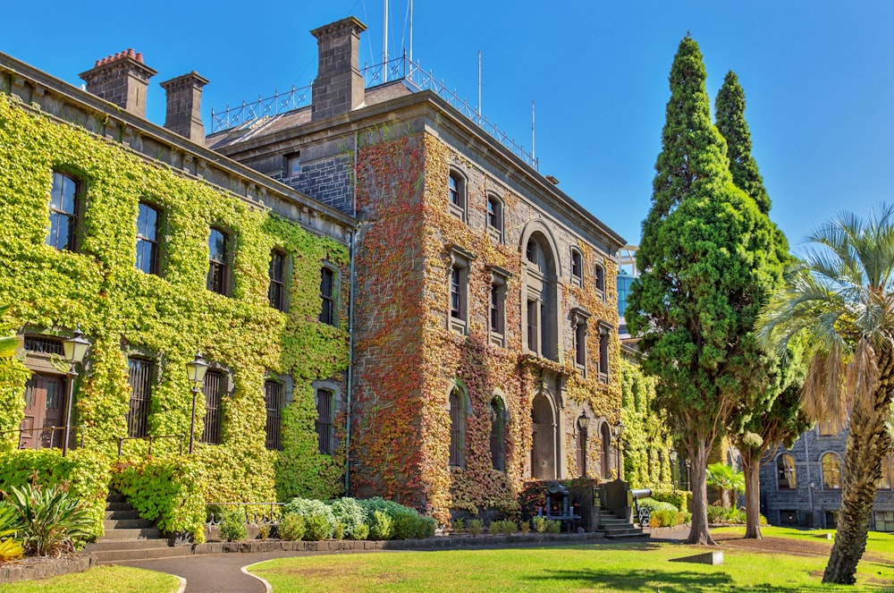 a large building with a lot of green plants on it