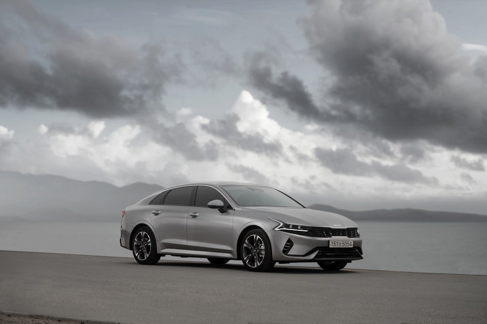 a silver car parked on the side of a road