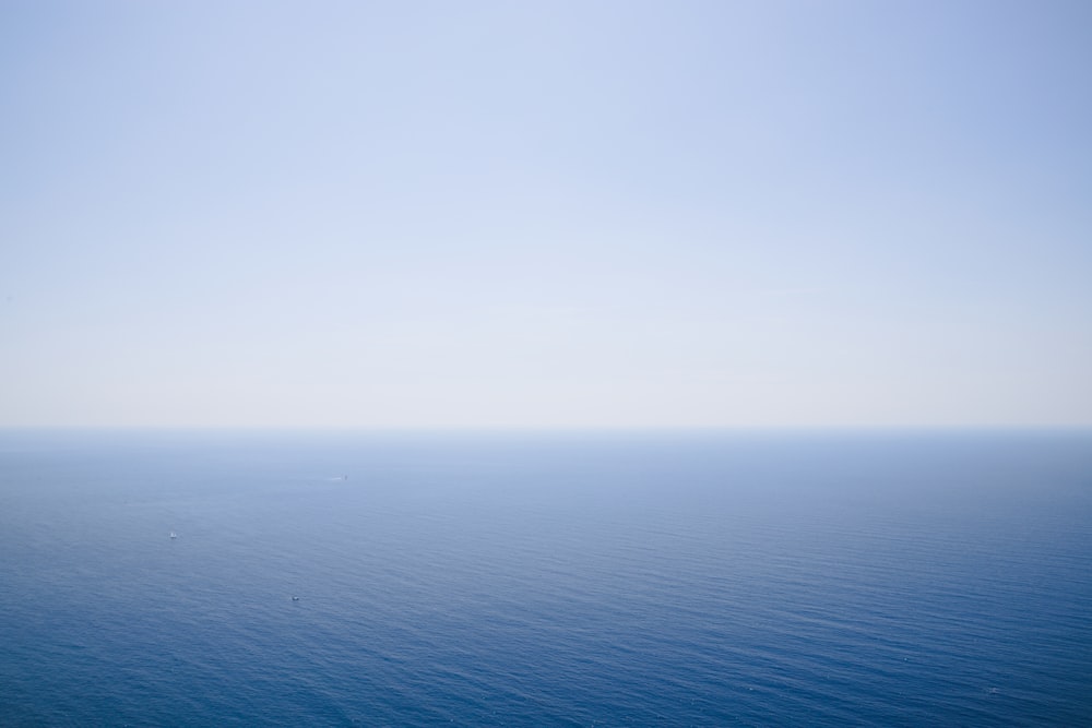 a large body of water with a sky background