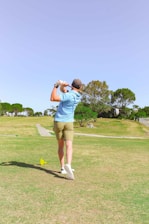 A diverse group of golfers enjoying a sunny day on the course, smiling and interacting.