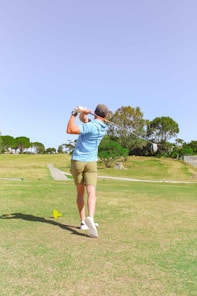 A casual golf outfit featuring a crisp polo and comfortable pants, perfect for a day on the course.