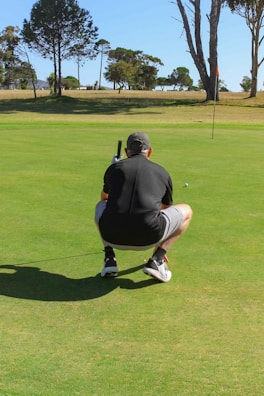 Golf training aid set up beside a putting green with a golfer practicing.