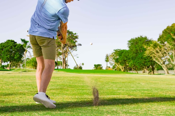 a man hitting a golf ball with a golf club