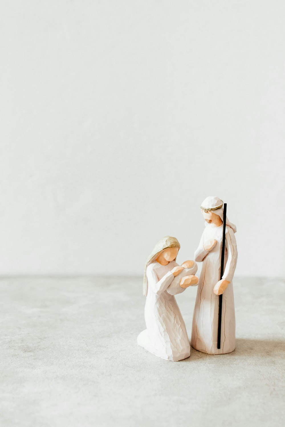 a figurine of two people holding hands