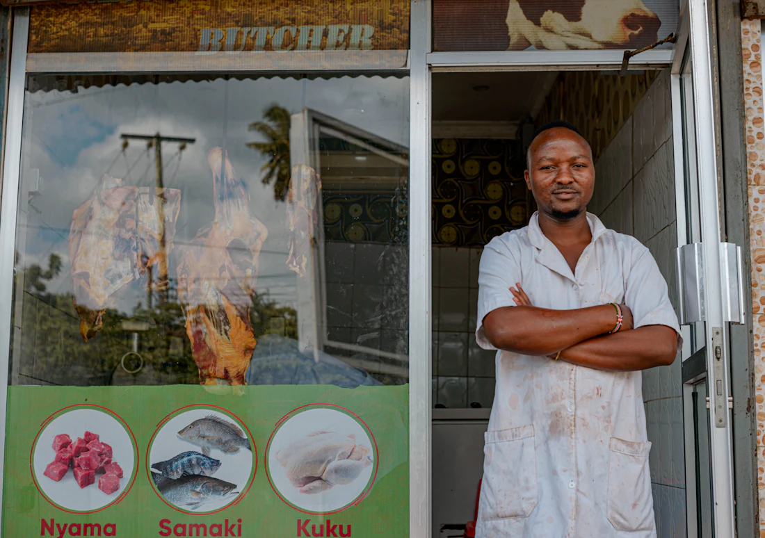 Business owner standing in front of his shop