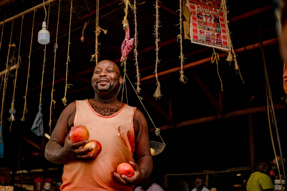 a man holding two apples in his hands