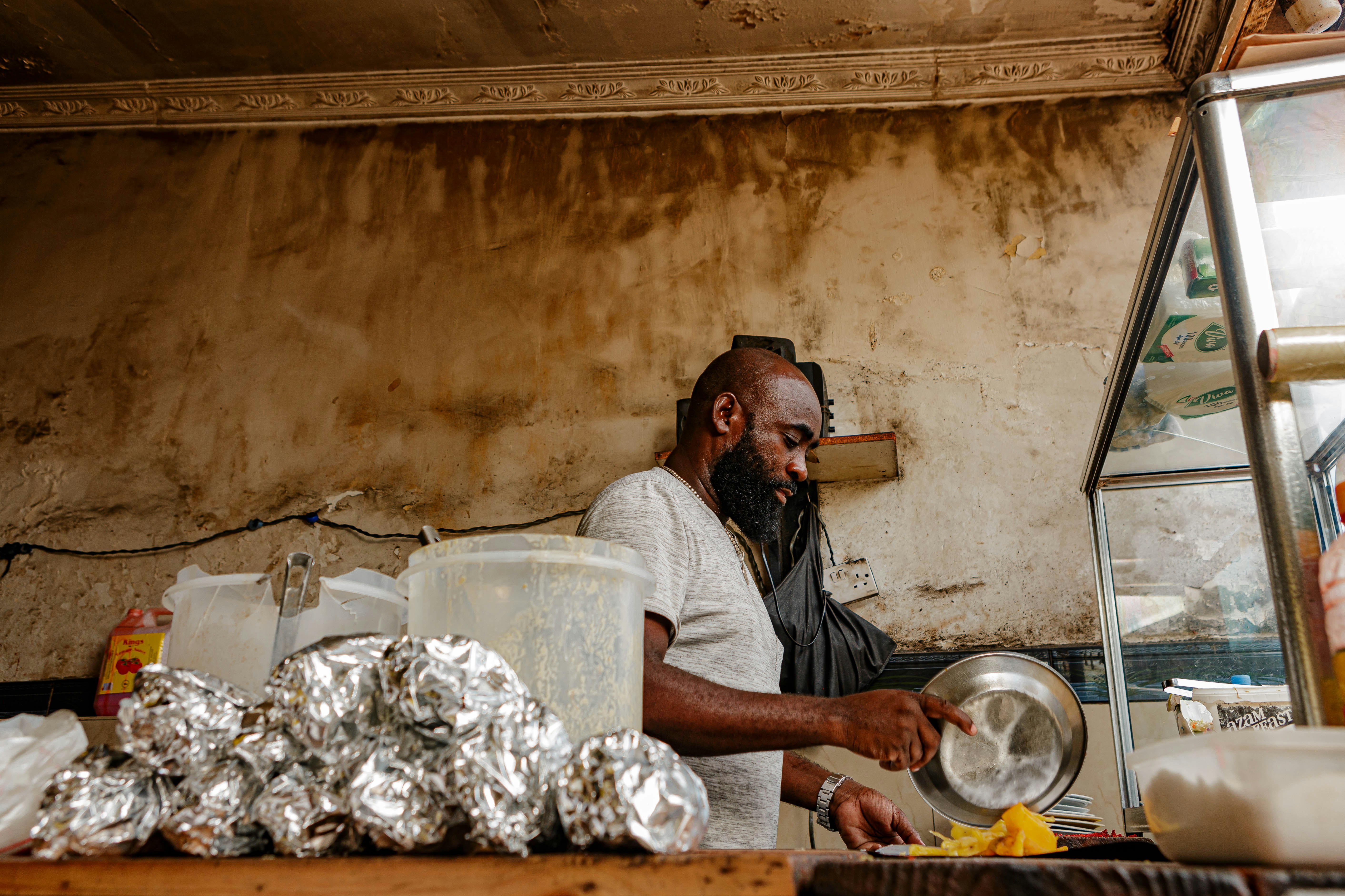 a man standing in front of a counter preparing food
