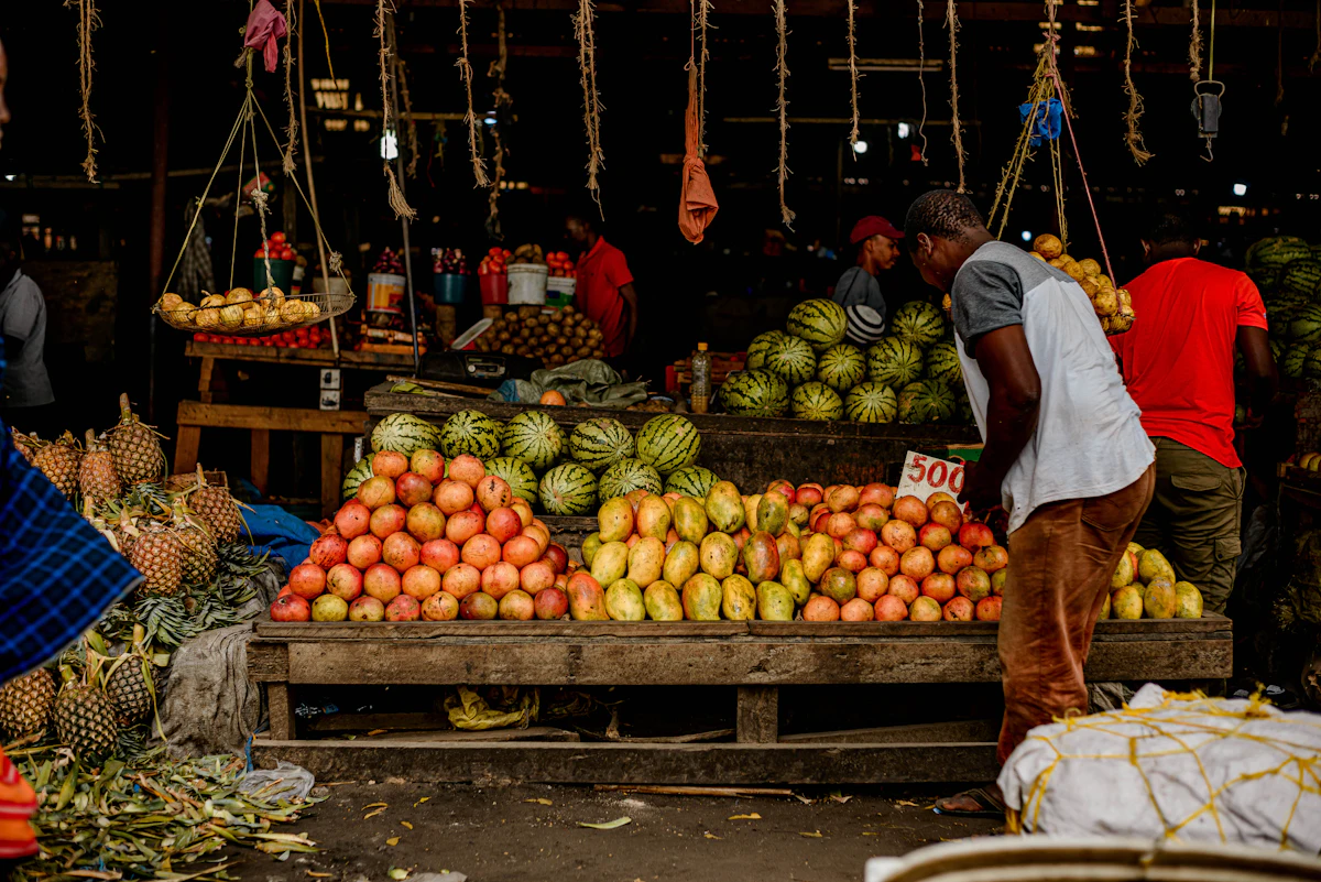 A trader standing proudly behind his fruit stall