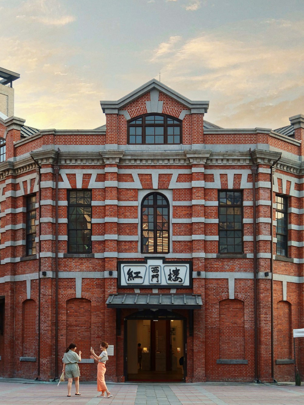 a couple of people standing in front of a building