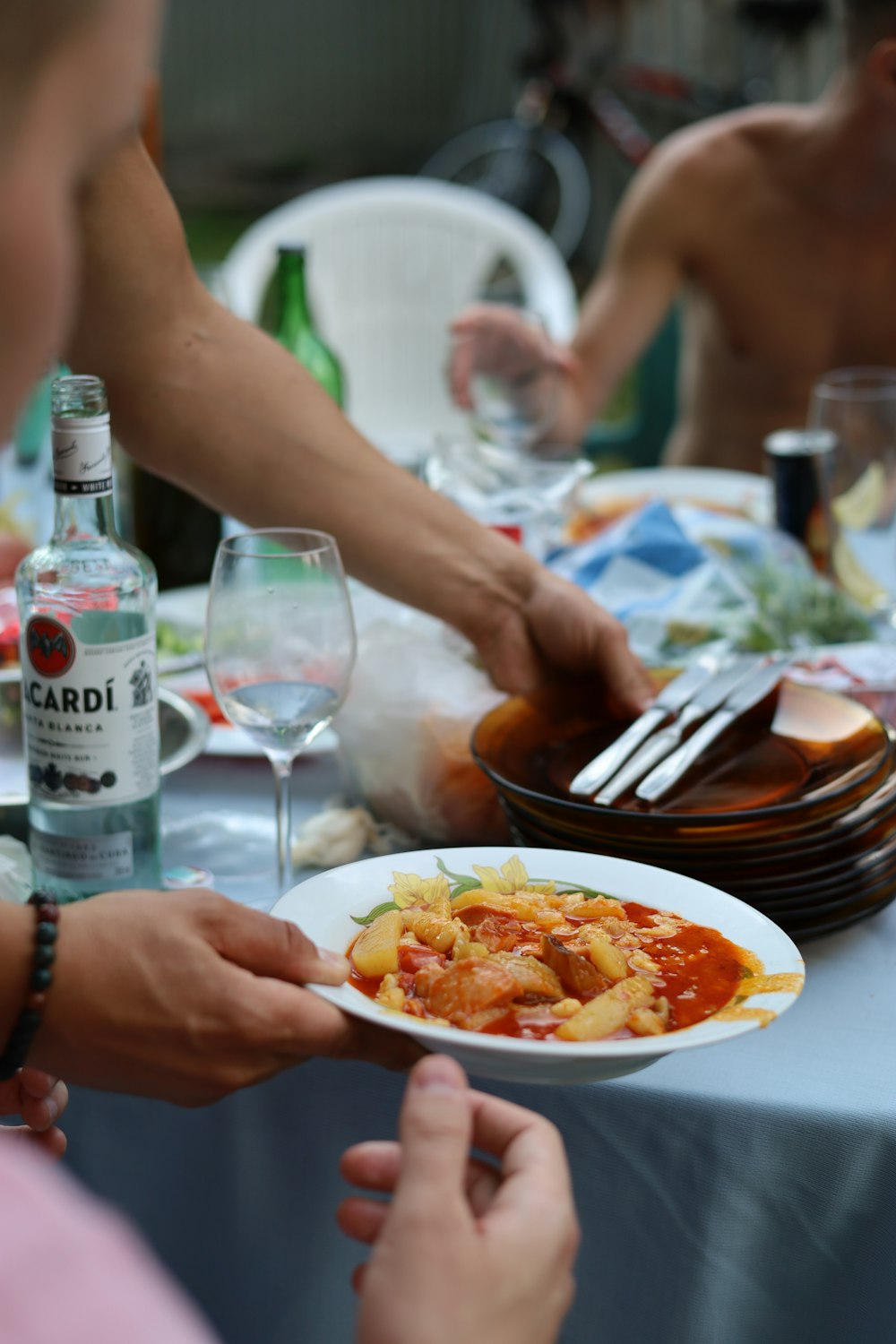 a group of people sitting around a table with plates of food