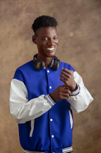 Smiling mature person wearing headphones, looking hopeful and relaxed.
