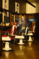 A row of classic barber chairs with vintage decor reflecting the stylish vibe of Amal Raayq.