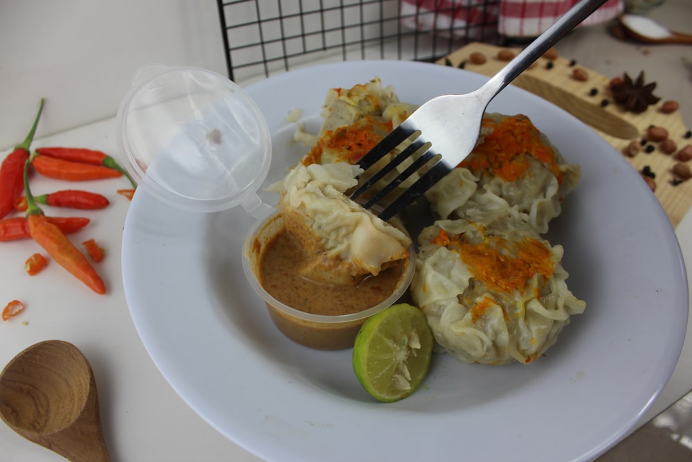 a white plate topped with food and a fork