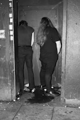 A tense standoff between two survivor groups in a desolate street.