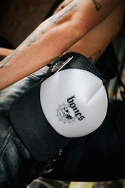 A close-up of a black premium t-shirt featuring a detailed skull and motorcycle design.