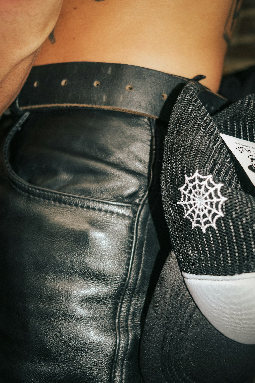 a close up of a person wearing a leather jacket