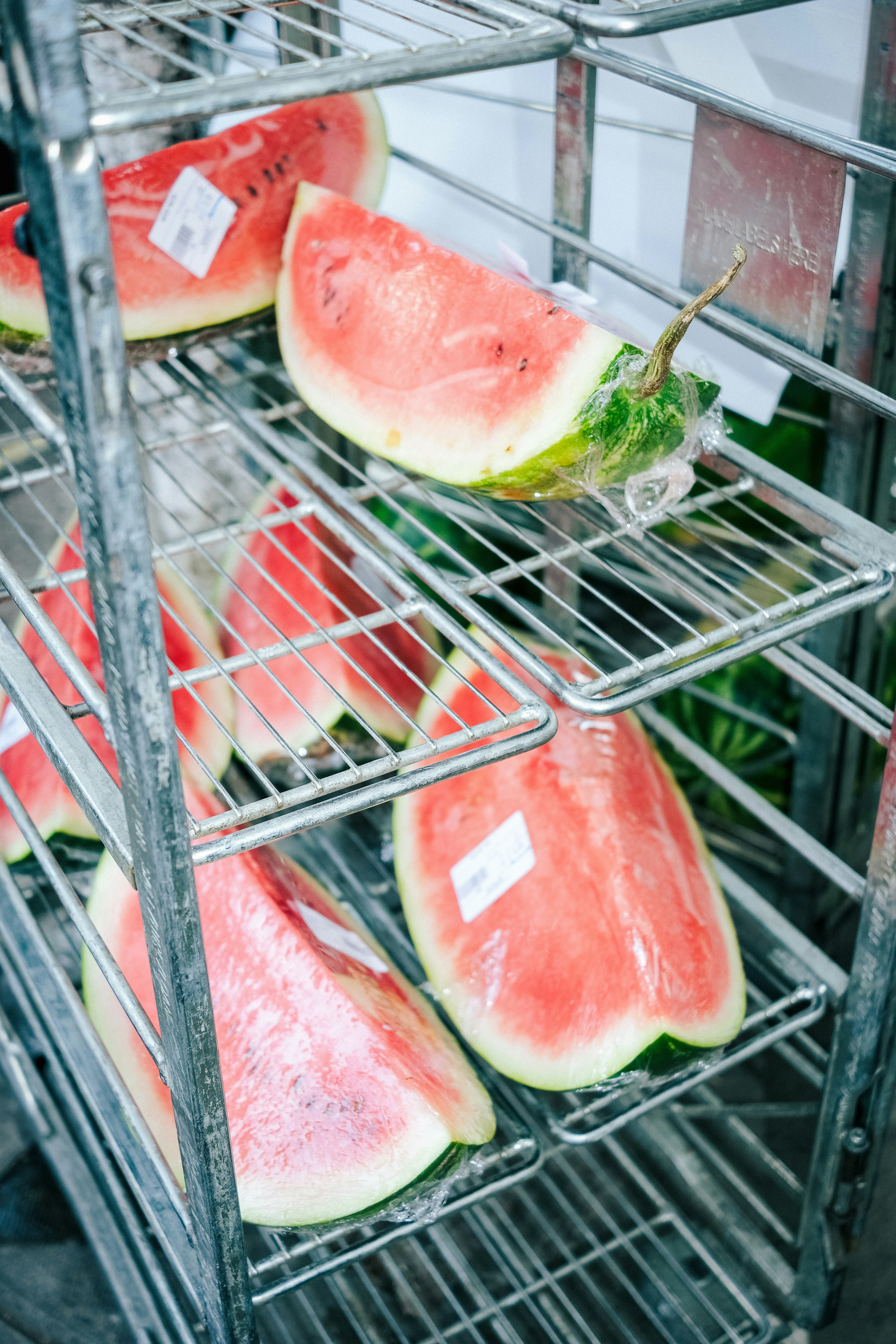 A metal rack filled with slices of watermelon photo – Free Fruit Image ...