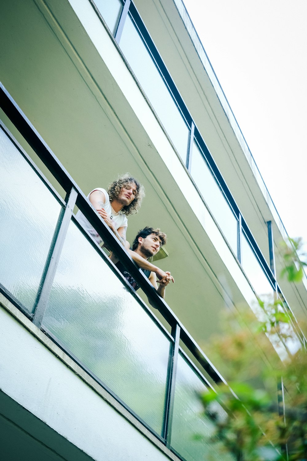 a couple of people that are looking out of a window