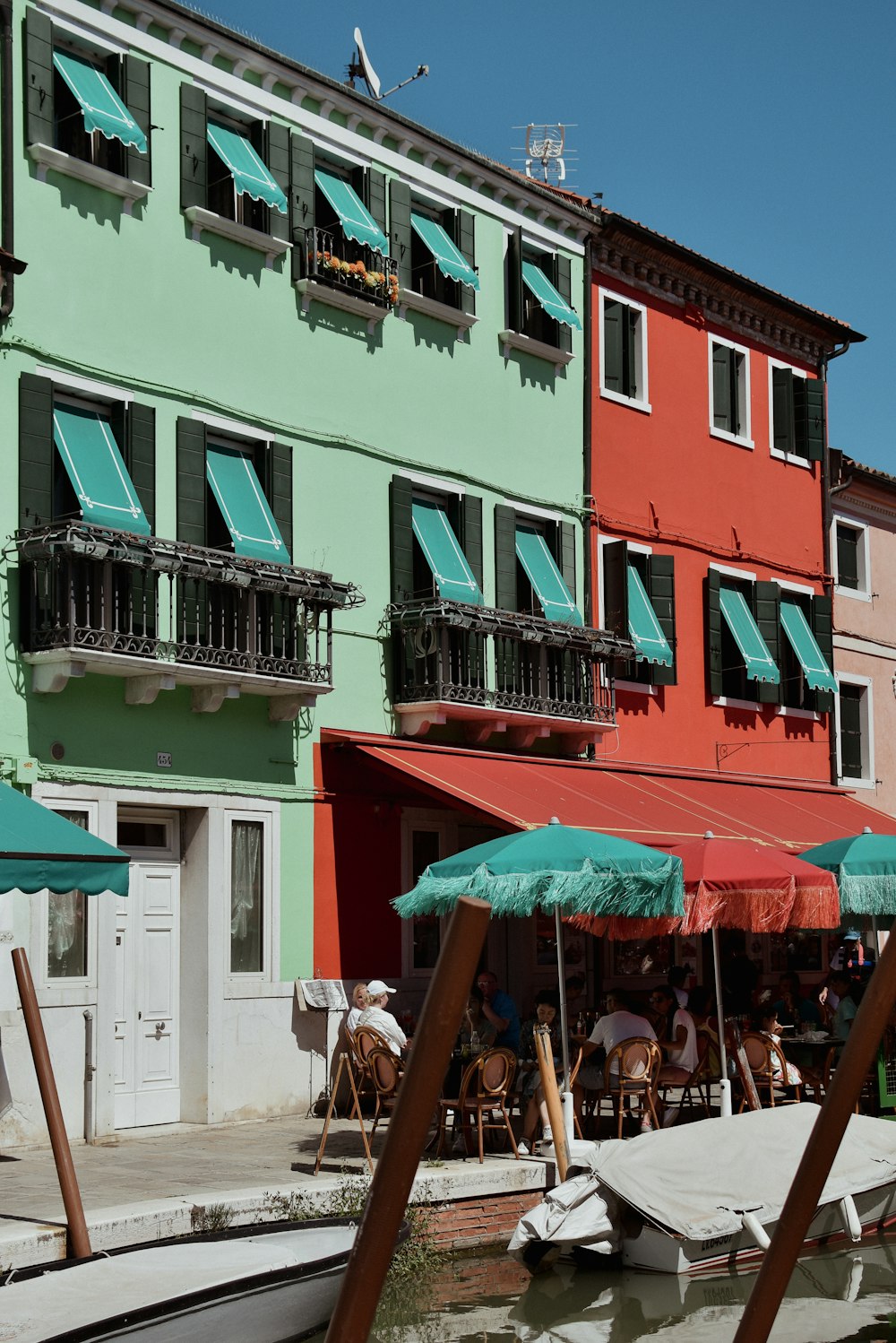 a row of colorful buildings next to a body of water