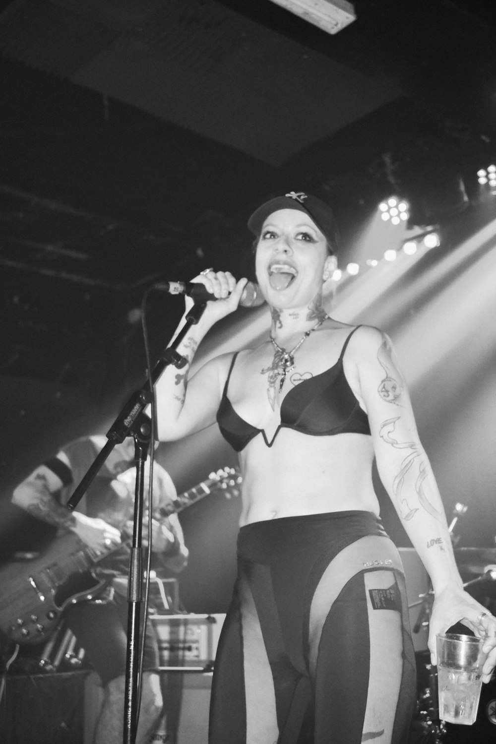 a woman in lingerie singing into a microphone