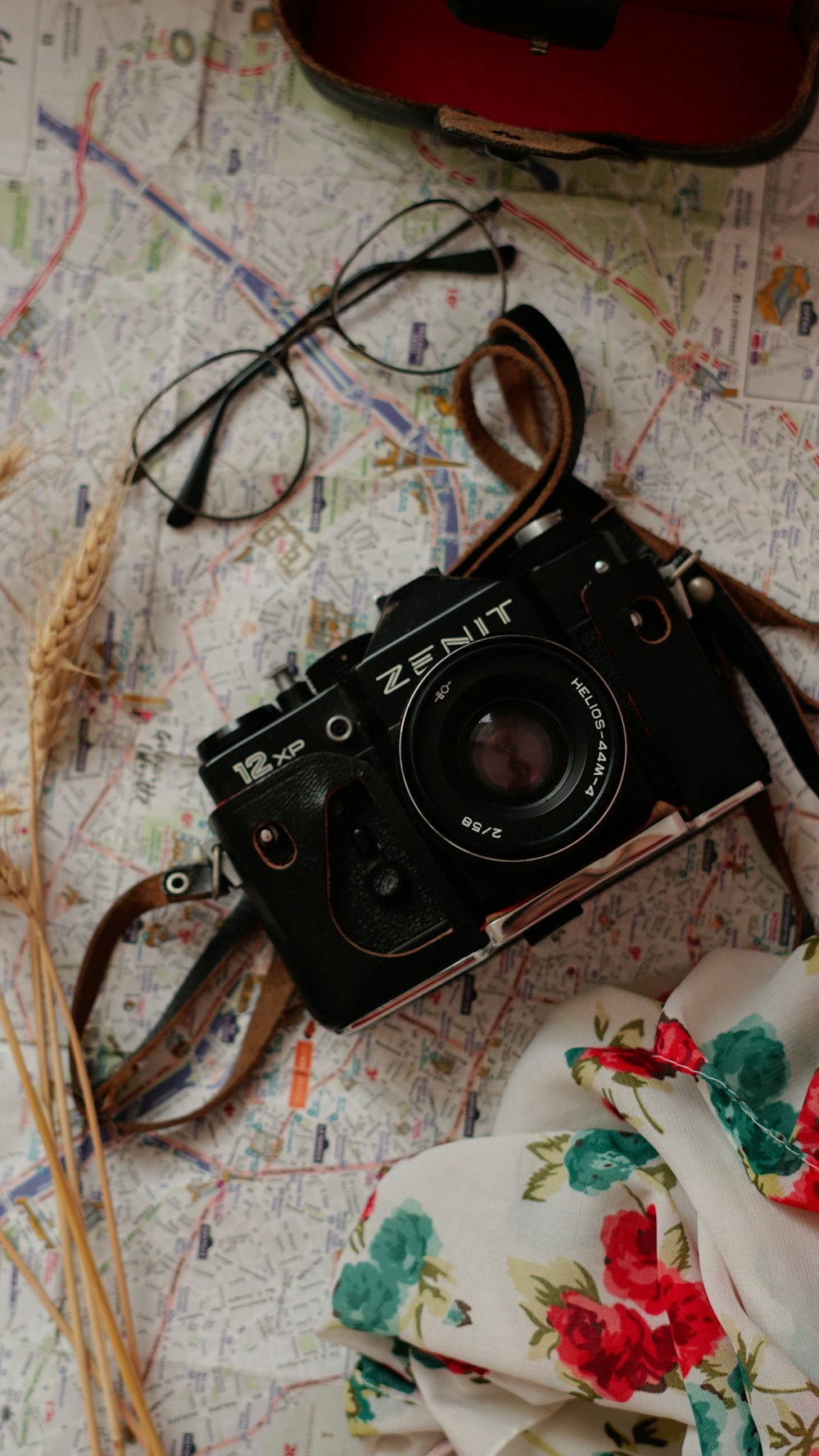a camera and a scarf on a map