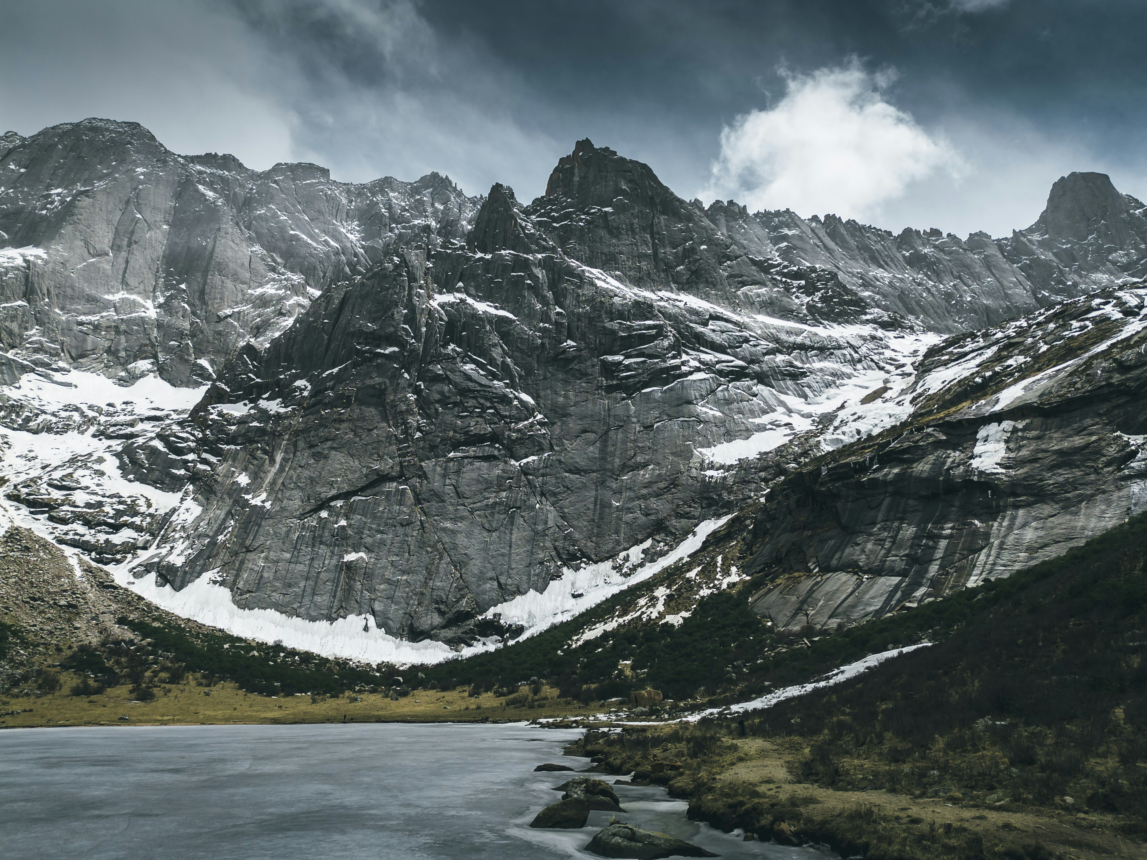 a mountain range with a body of water in the foreground