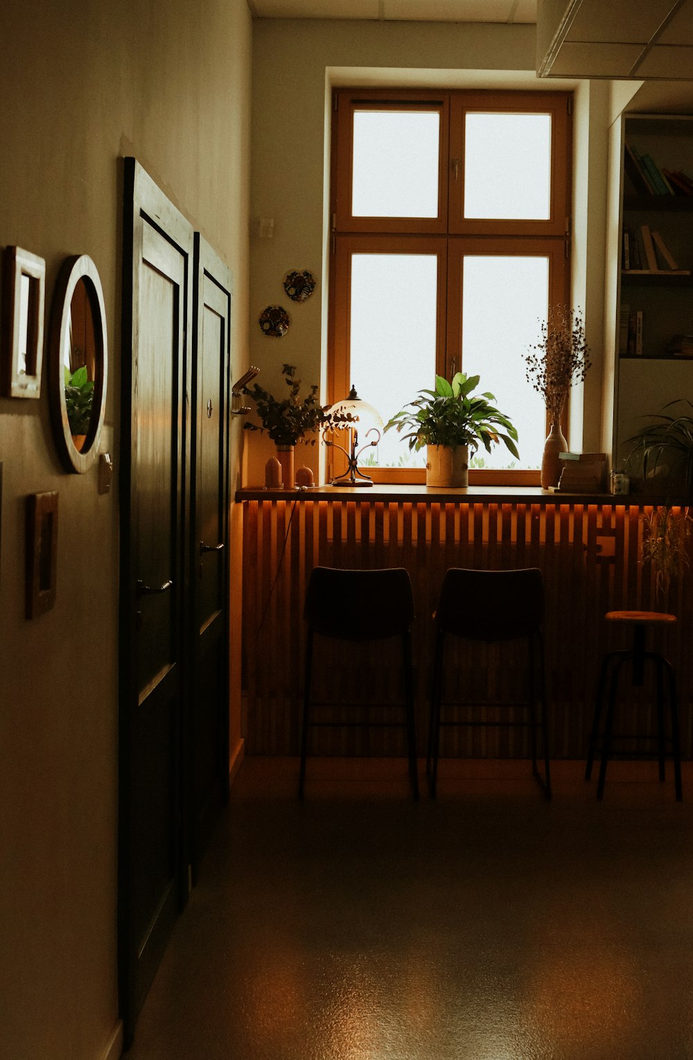 a kitchen with a table and chairs next to a window