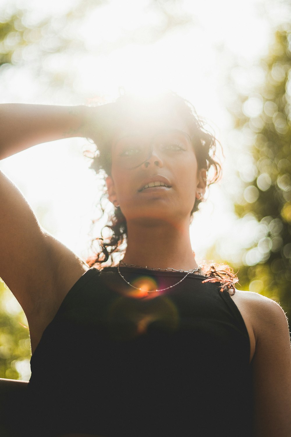 a woman in a black top is posing for a picture