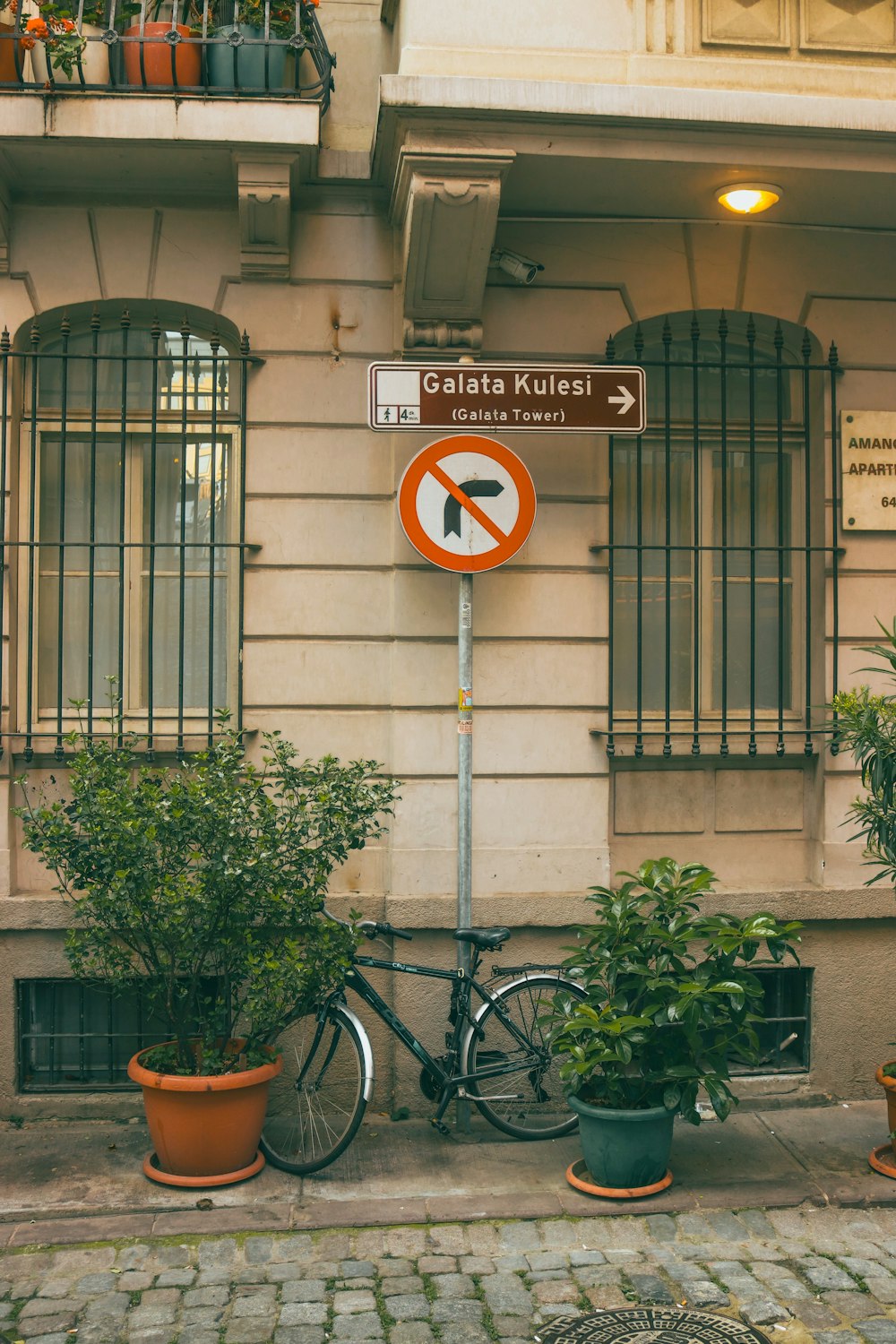 a bicycle parked next to a no right turn sign