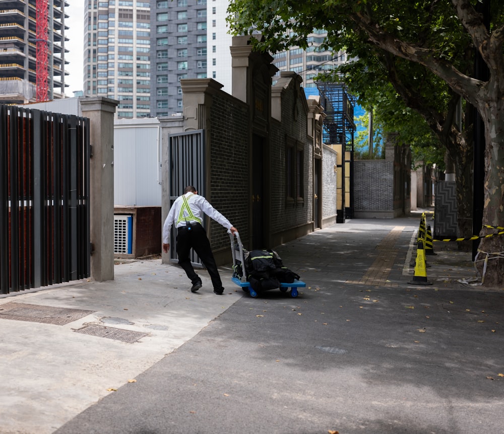 a man pushing a stroller down a city street