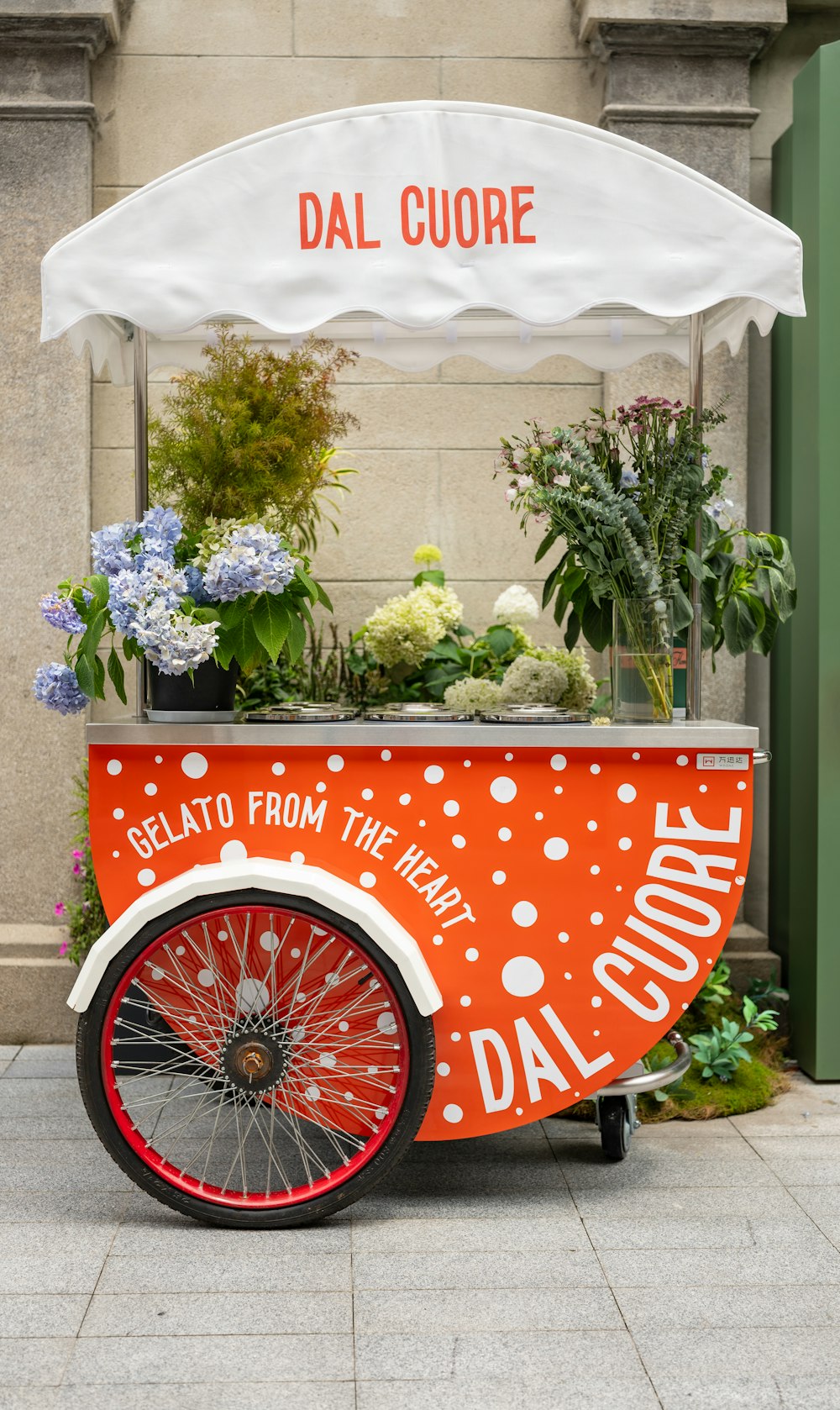 an orange and white cart with flowers in it