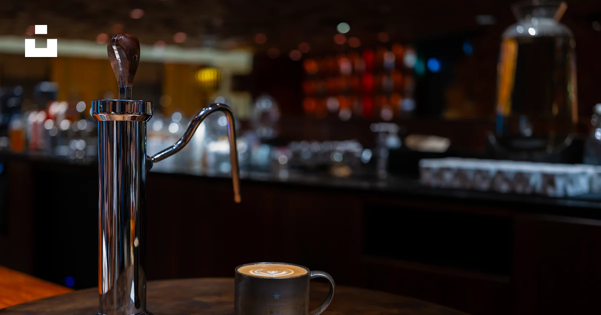 A cup of coffee sitting on top of a wooden table photo – Free Starbucks ...