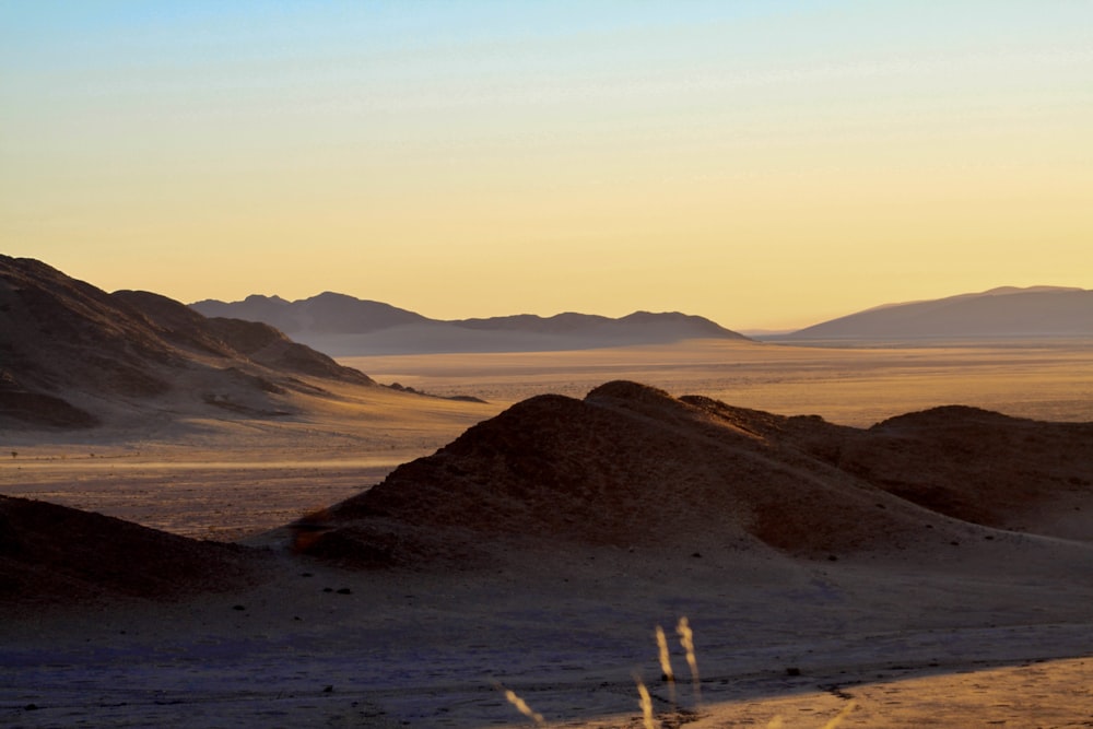 a desert landscape with mountains in the distance