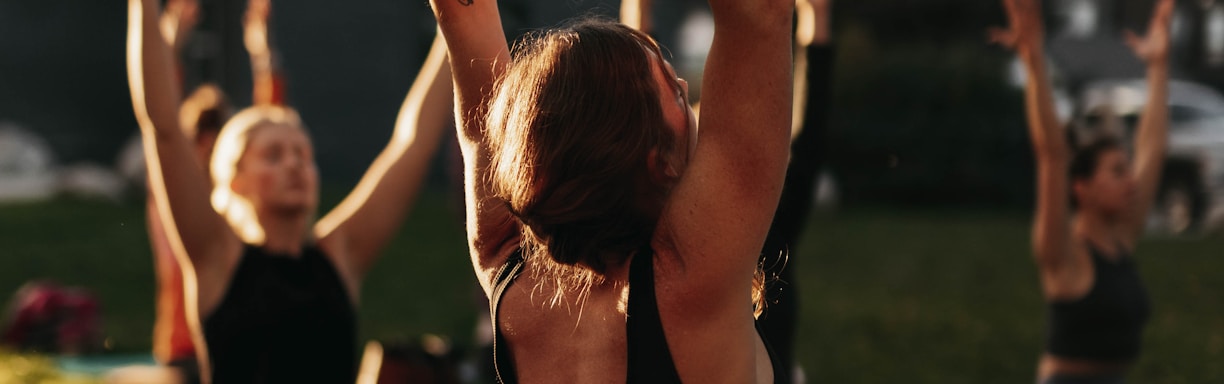 a group of people doing yoga in a park